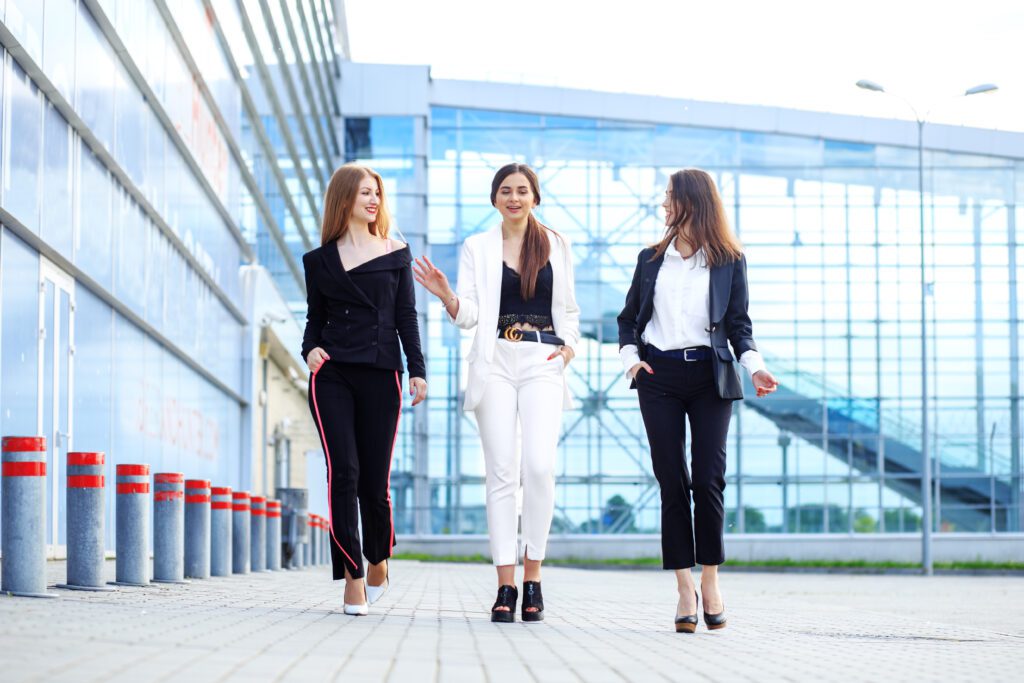 A group of managers discuss tasks on the go. Beautiful women. Concept for business, boss, work, team and success.