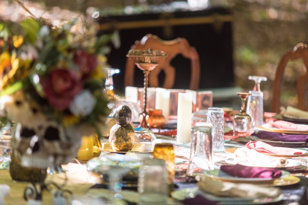 A shallow focus shot of a beautiful table setting and unique decorations at the outdoor wedding venue