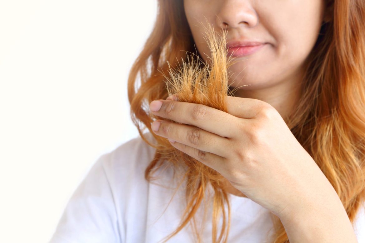Asain,Woman,Holding,Her,Long,Hairs,That,Make,Color,Treatments. prevent split ends